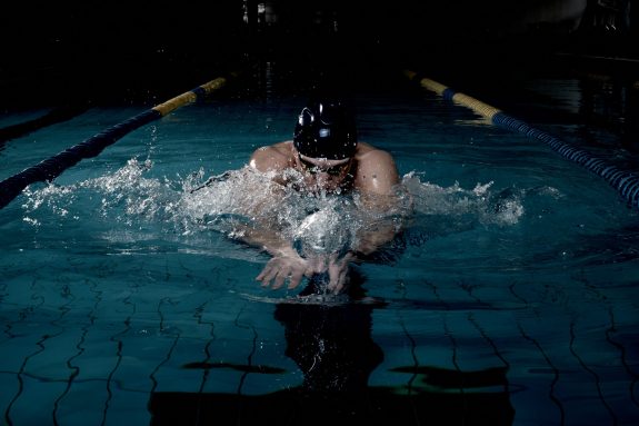 Sportsman swims in a swimming pool